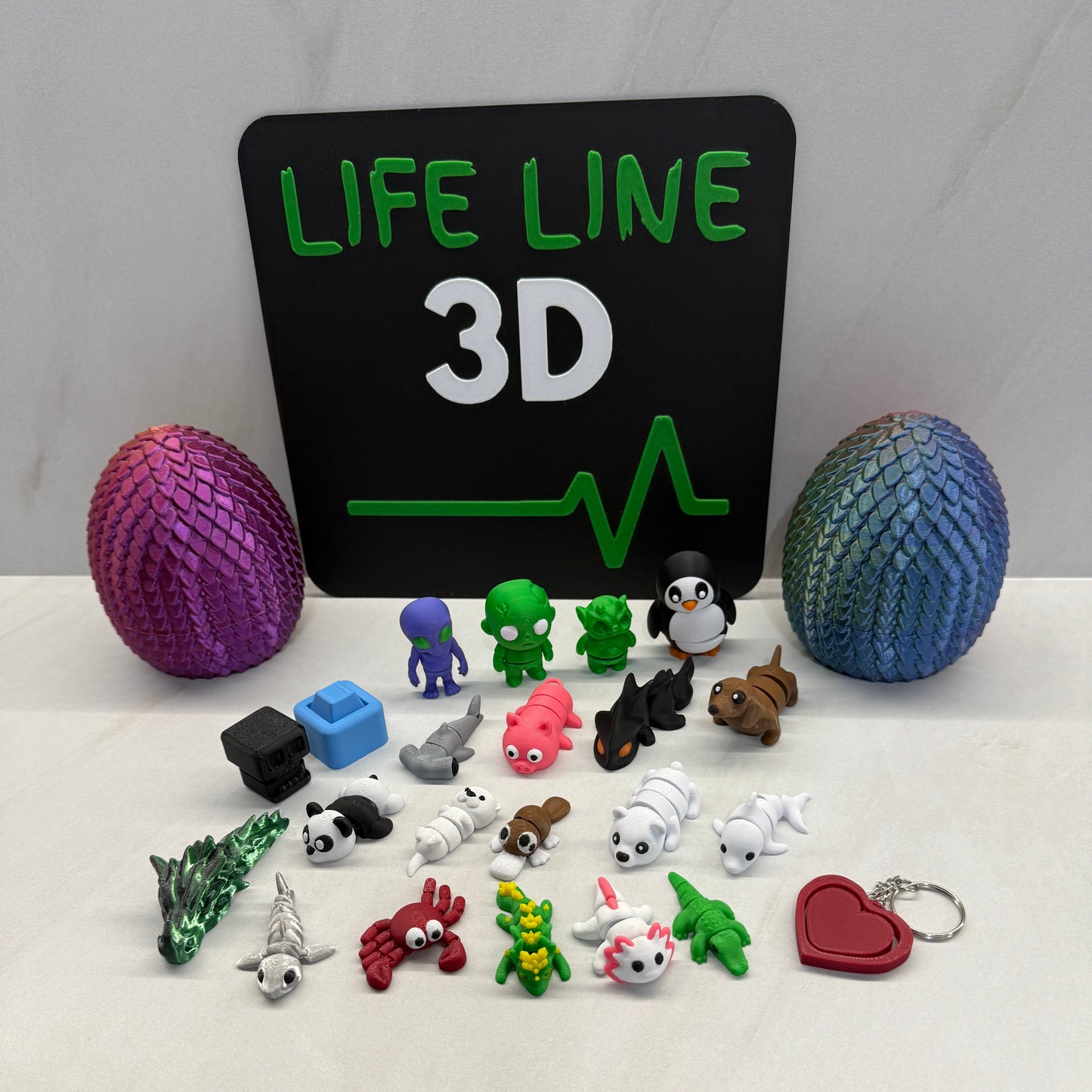 Collection of small figurines and a 'Lifeline 3D' board on a white background