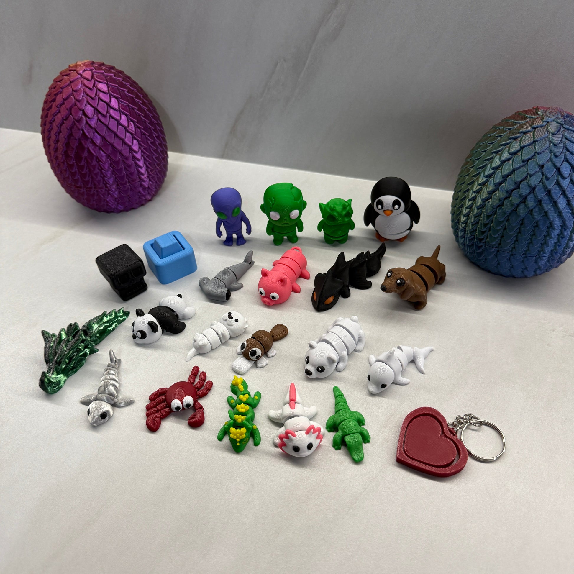 Collection of colorful keychains and figurines on a white surface