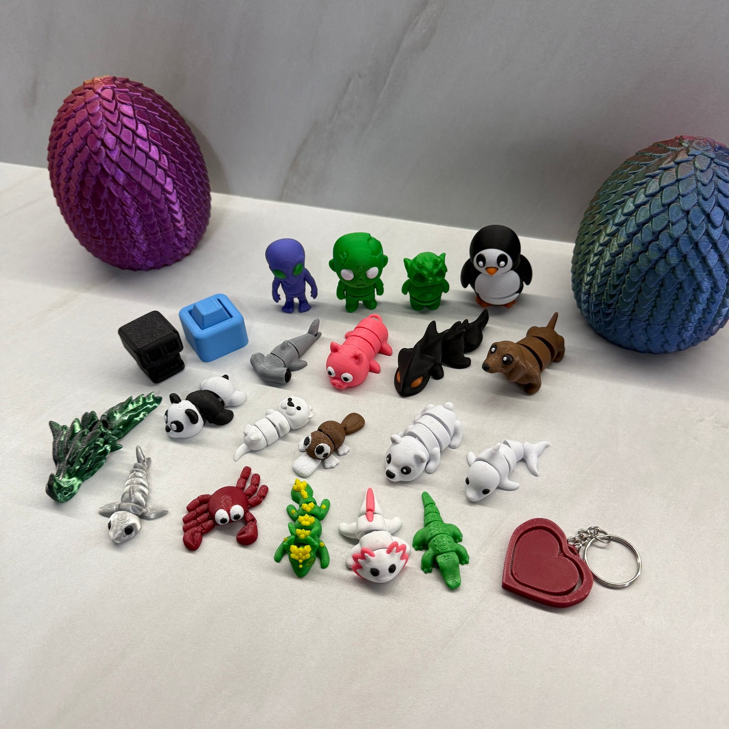 Collection of colorful keychains and figurines on a white surface