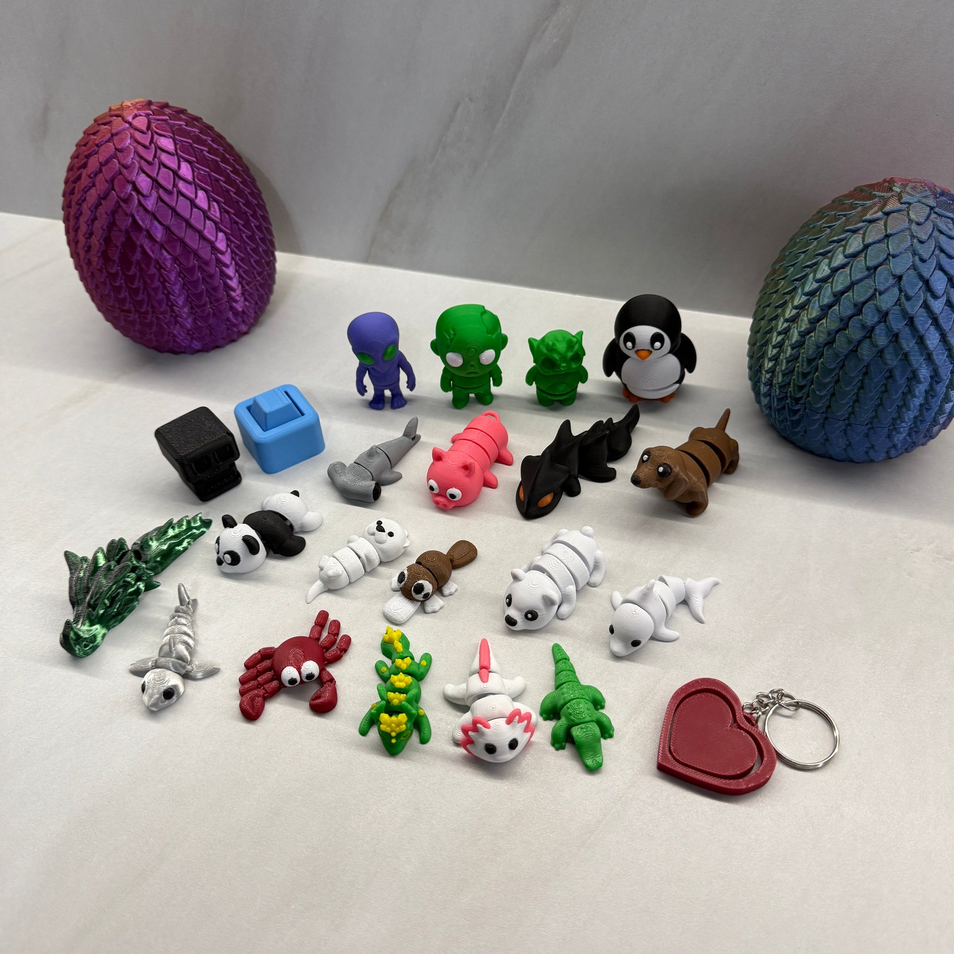 Collection of colorful keychains and figurines on a white surface