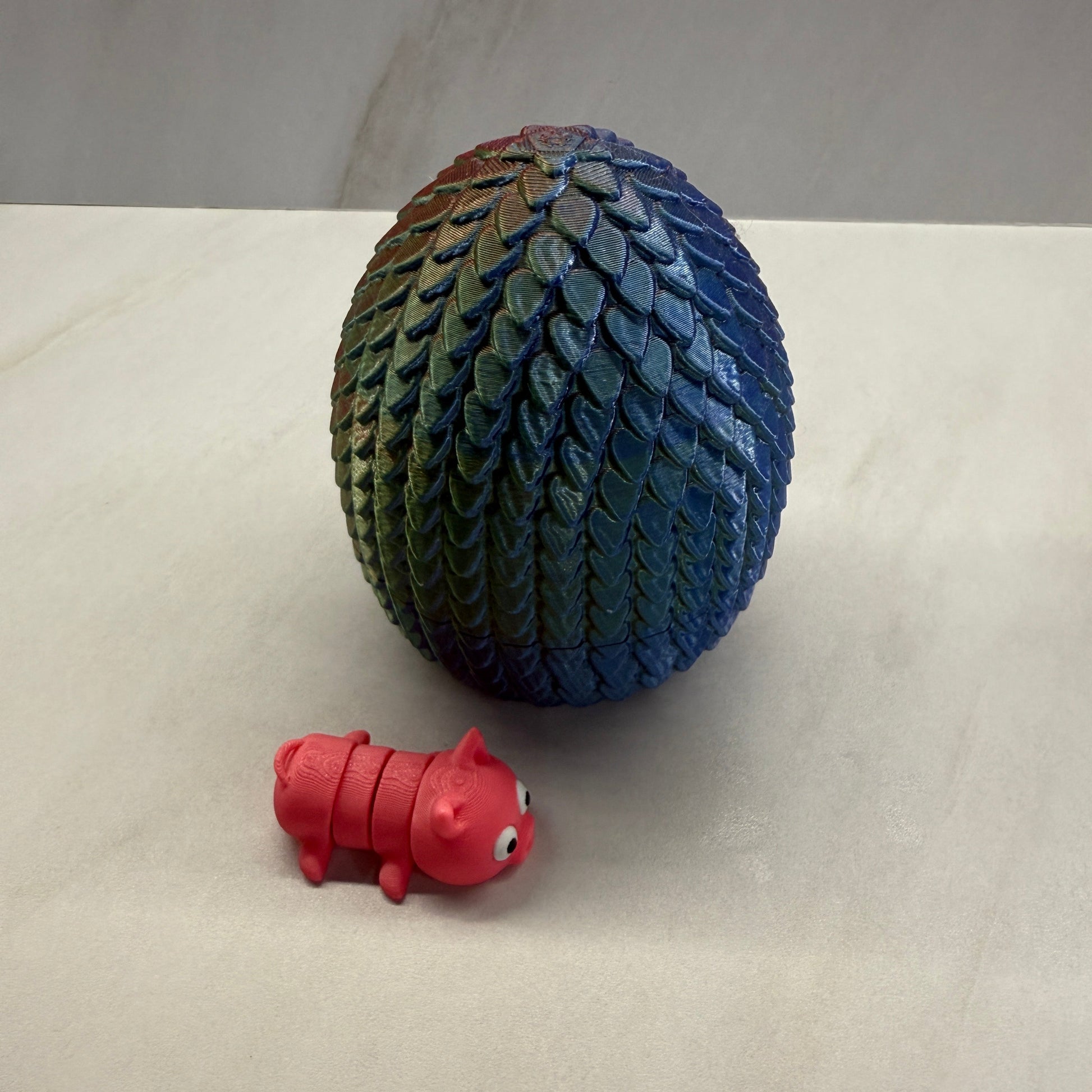 Blue textured ball and red toy on a light gray background