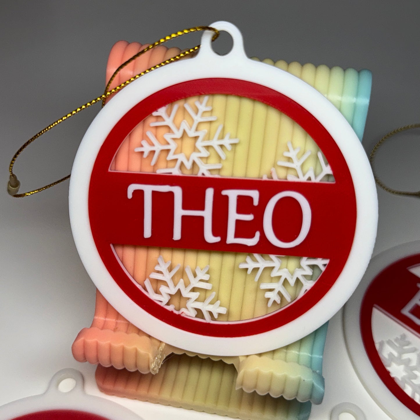Decorative ornament with 'THEO' branding on a plain background