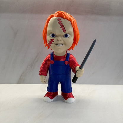 Toy figure with orange hair and a knife on a white background