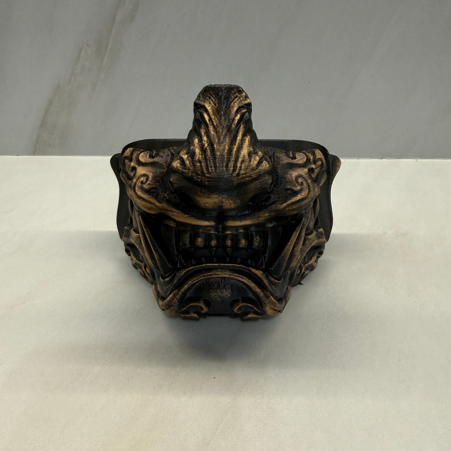 Decorative bronze finial on a white background