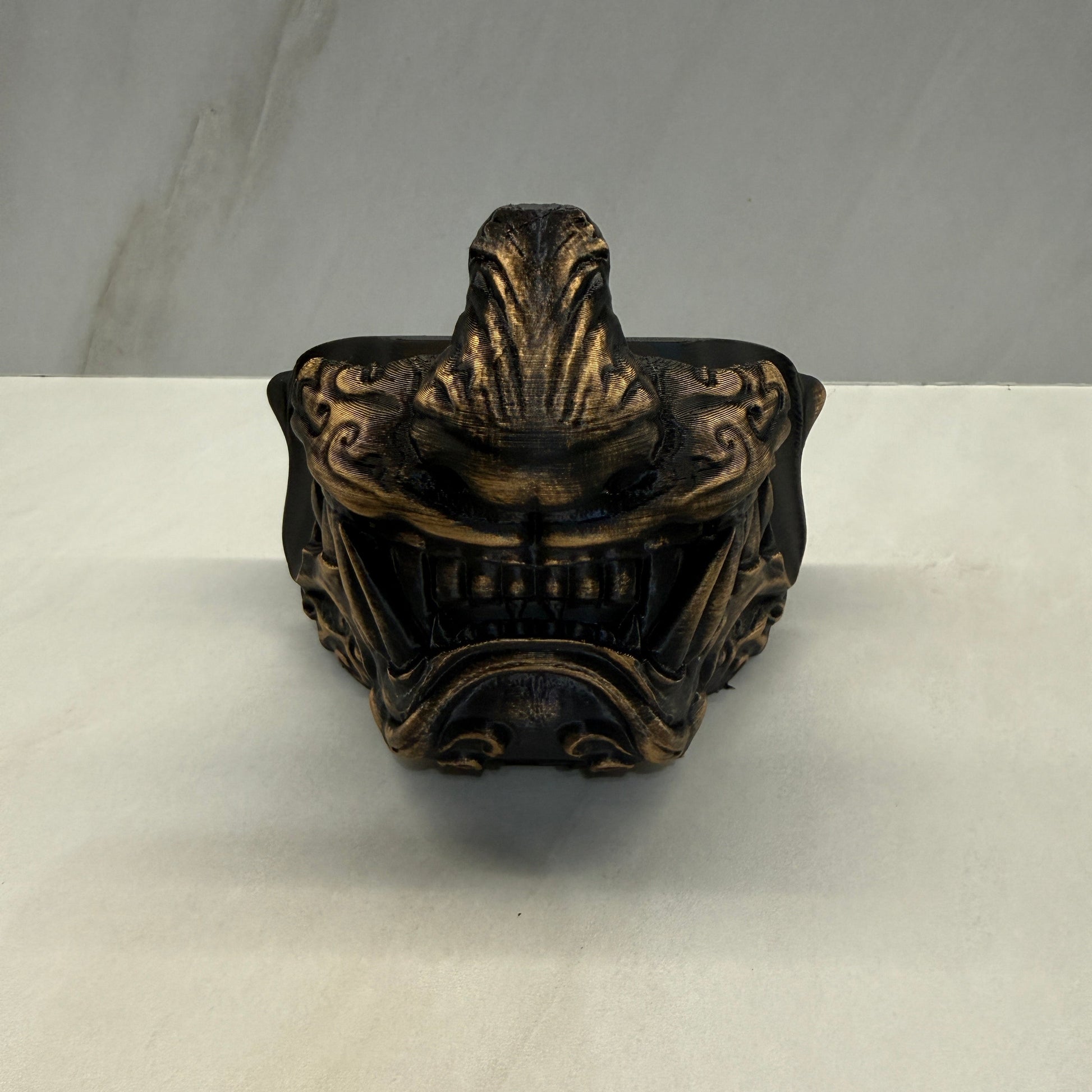 Decorative bronze finial on a white background