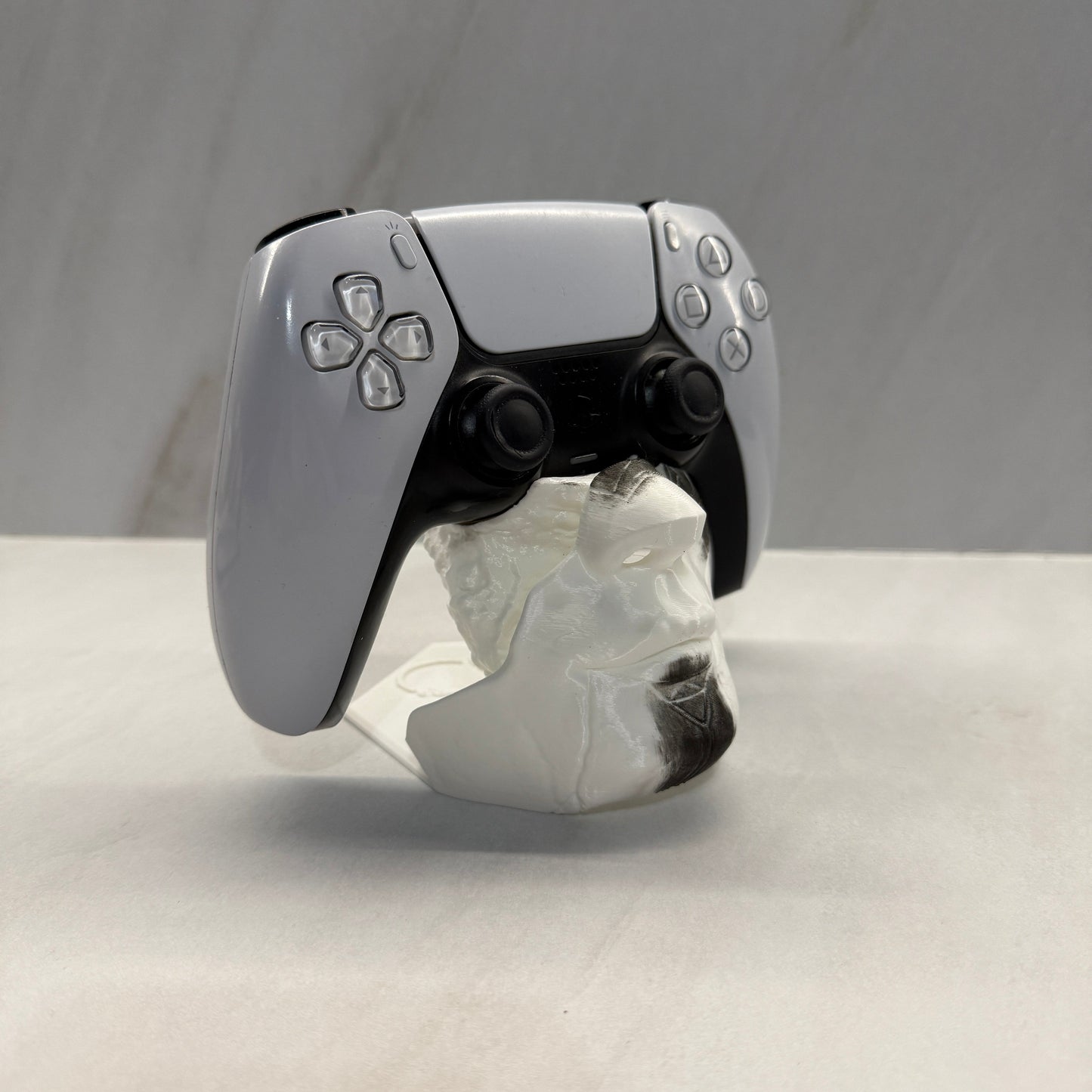 Gaming controller attached to a shower head with a white curtain in the background