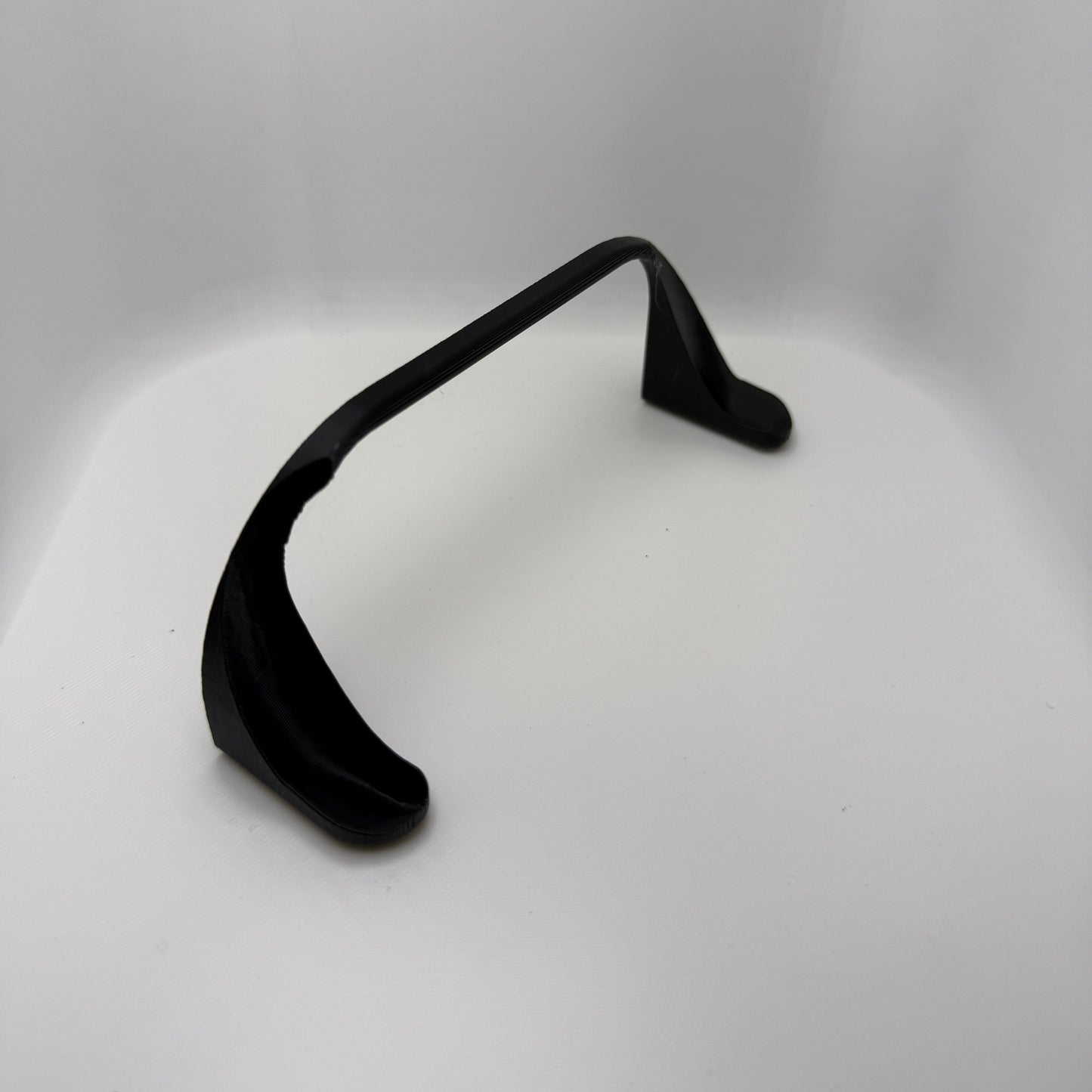 Black earbud on a white background