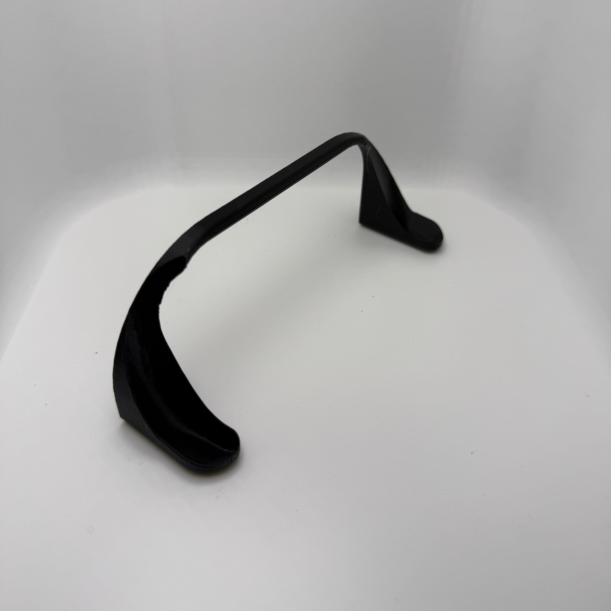 Black earbud on a white background