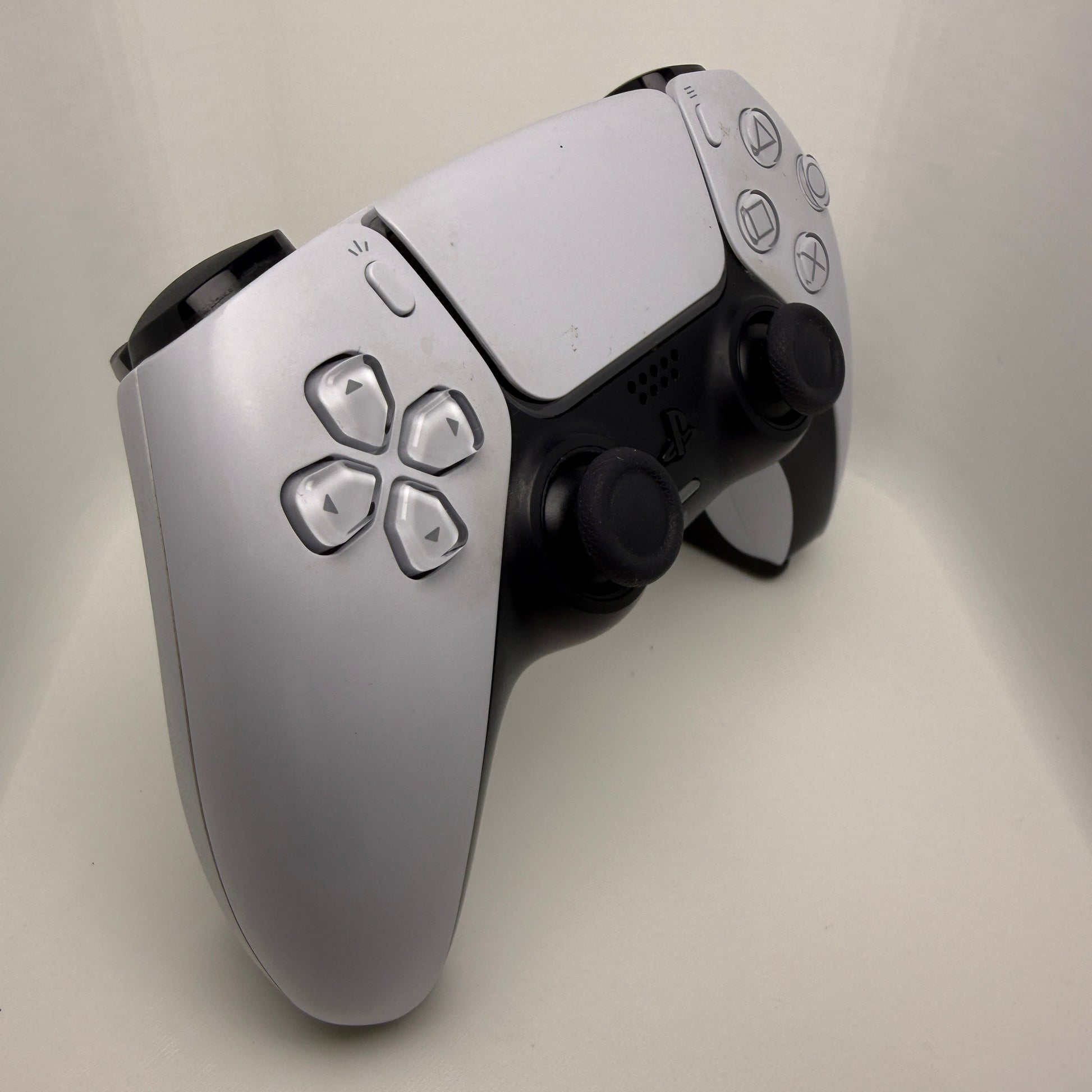 Close-up of a gaming controller on a light gray background