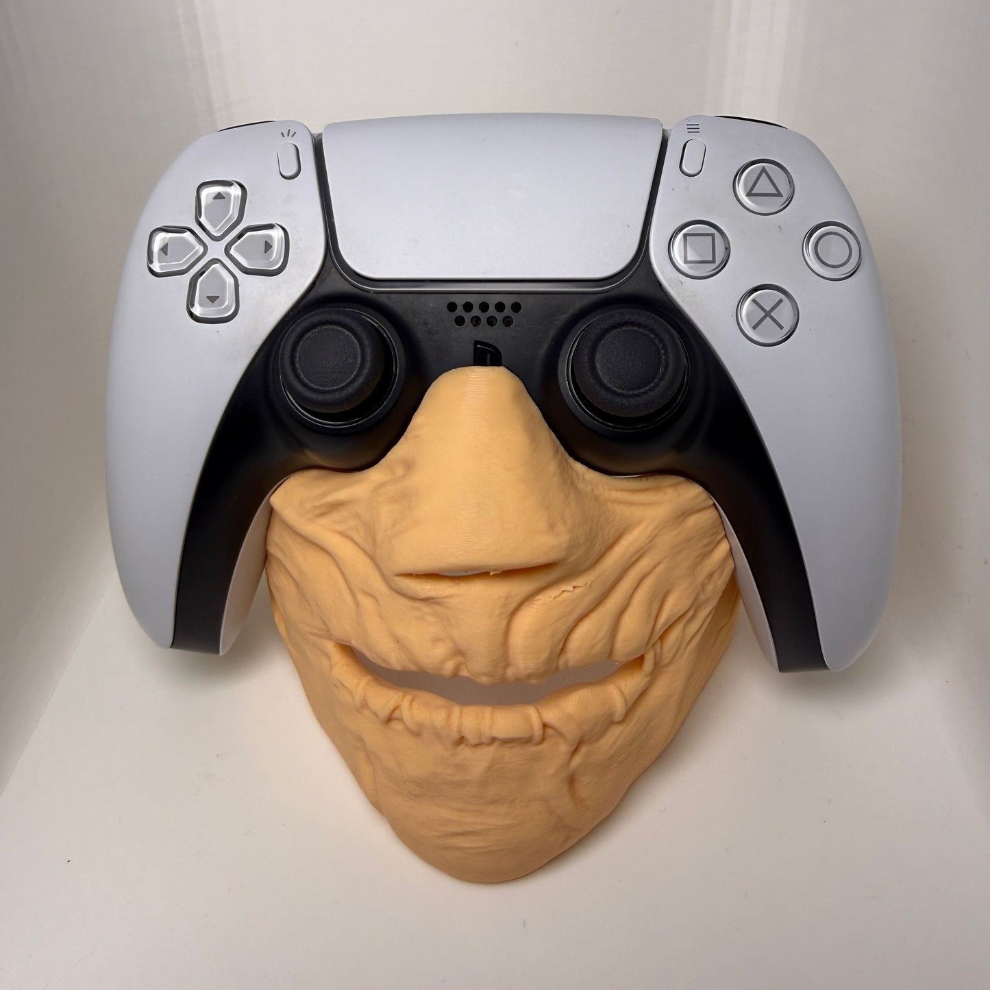 Gaming controller with a brain-shaped object on a white background