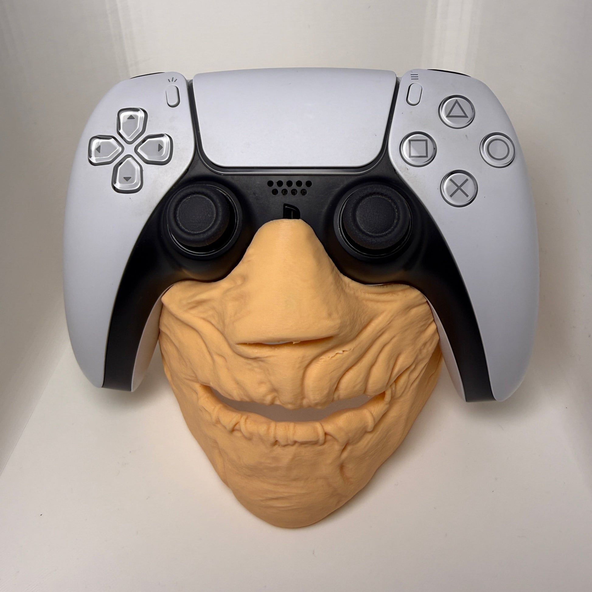 Gaming controller with a brain-shaped object on a white background
