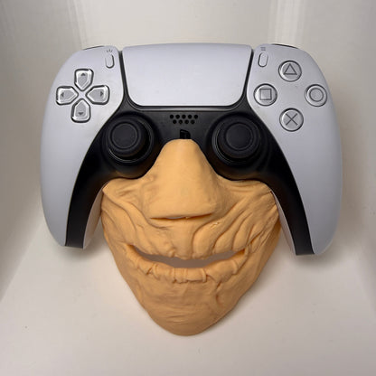 Gaming controller with a brain-shaped object on a white background