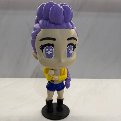 Toy figure with purple hair and white face on a white background
