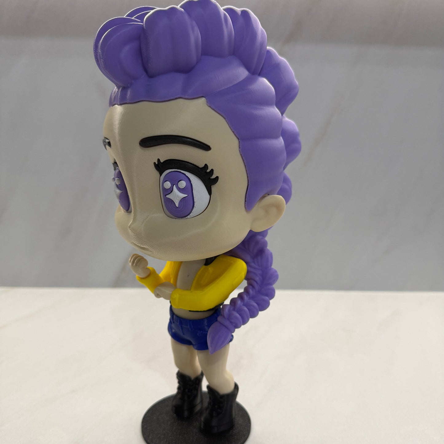Toy figure with purple hair and a star on a white background