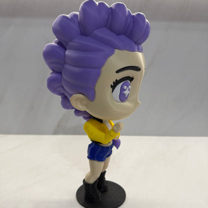 Purple character with a yellow bow attached to a white wall