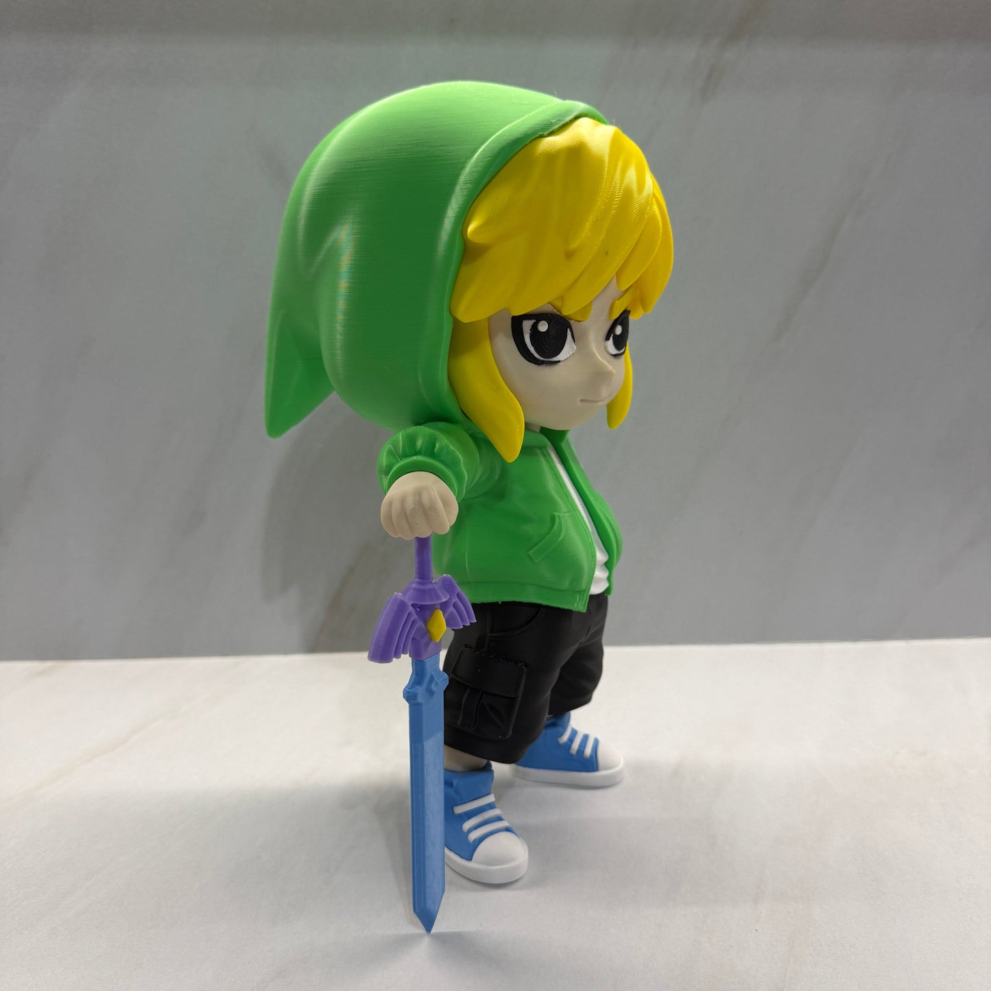 Toy figure with green outfit and yellow head on a white background