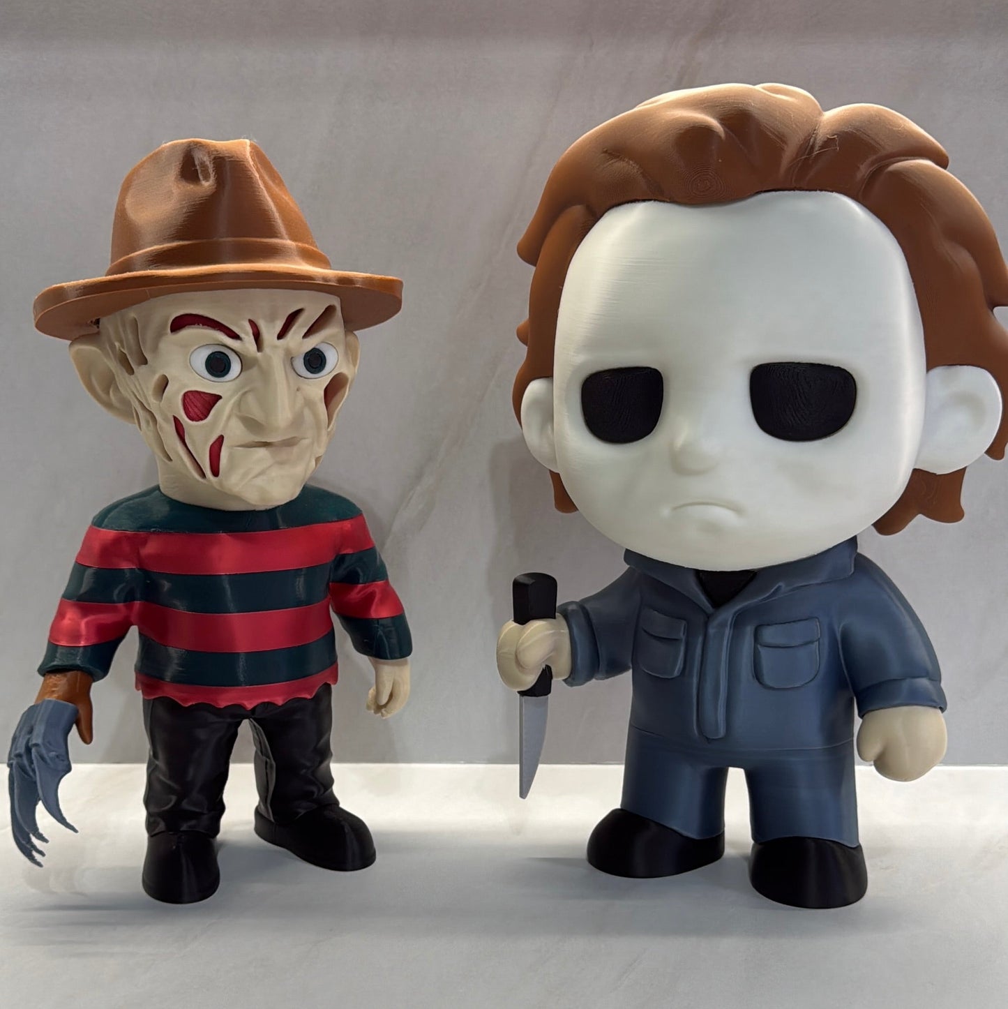 Two horror-themed figurines on a plain background