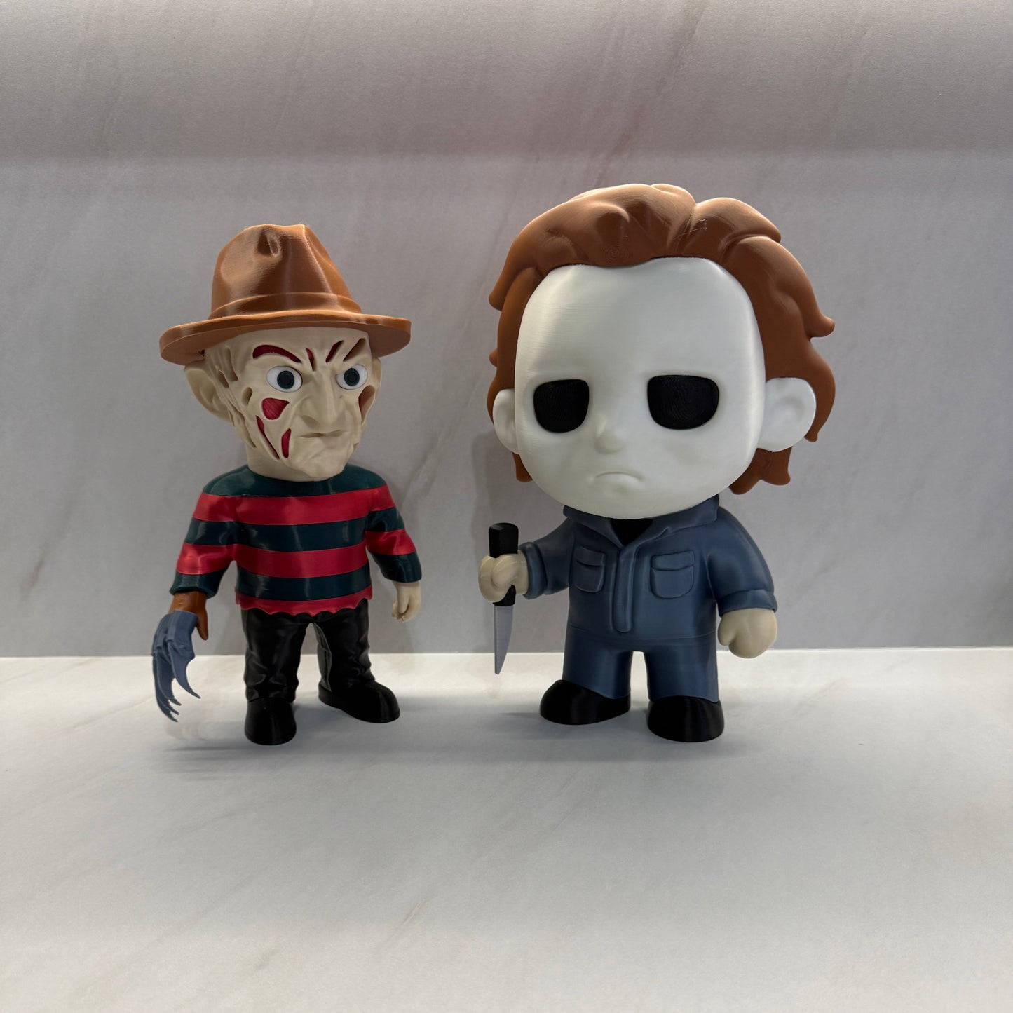 Two Halloween-themed figurines on a white background