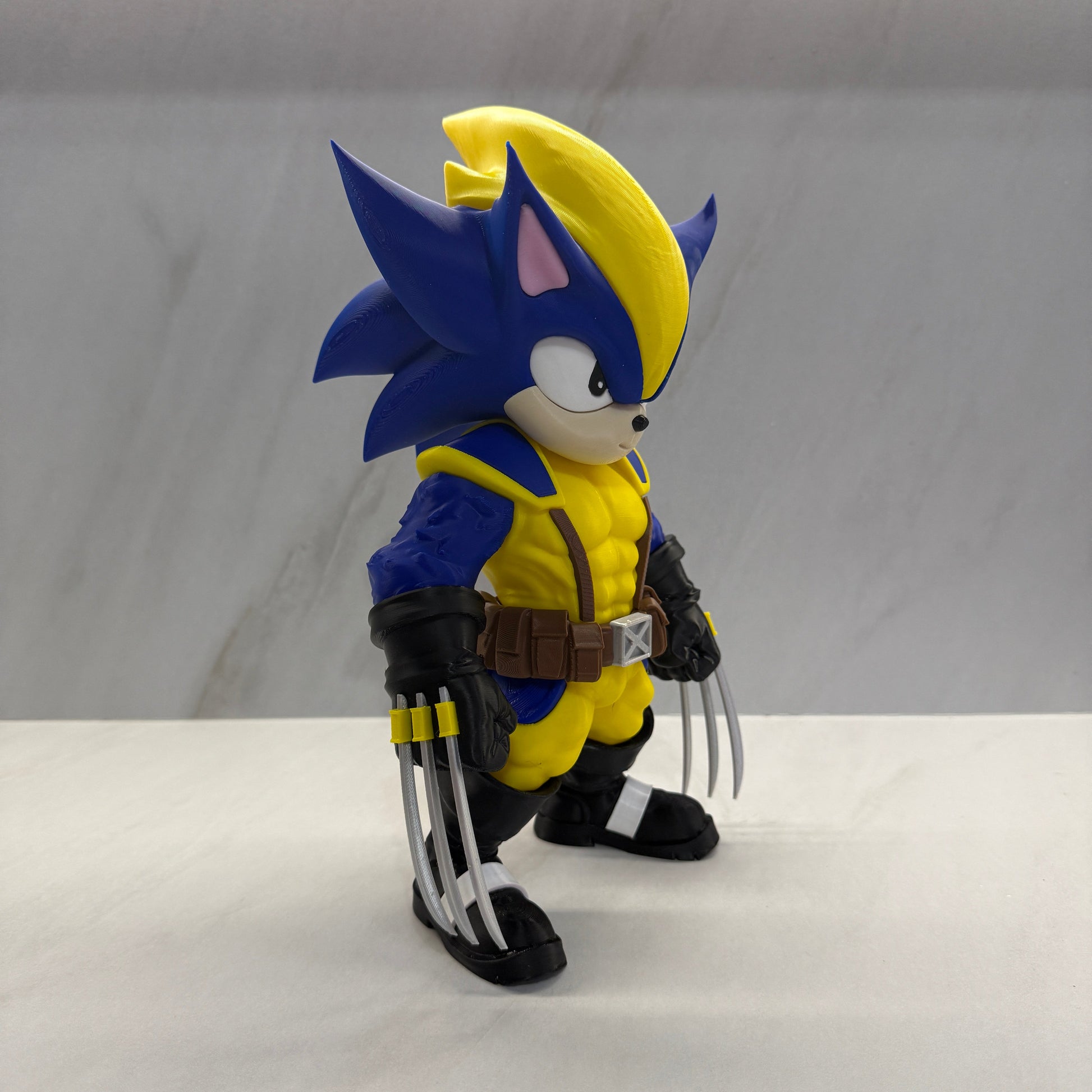 Toy figure of a character with blue and yellow hair, wearing a yellow outfit and black gloves, against a white background.