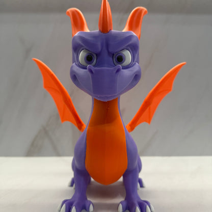 Purple and orange toy dragon on a white background