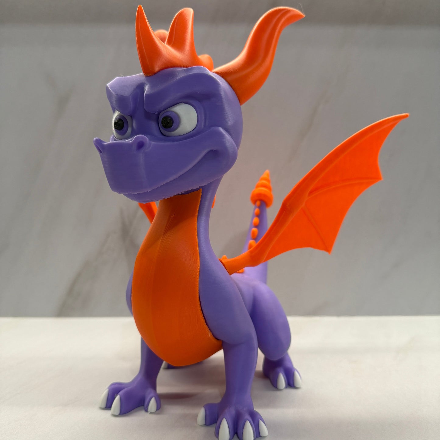 Purple and orange dragon-shaped object on a white background